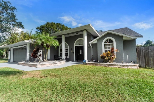 ranch-style home featuring a porch, a garage, and a front lawn