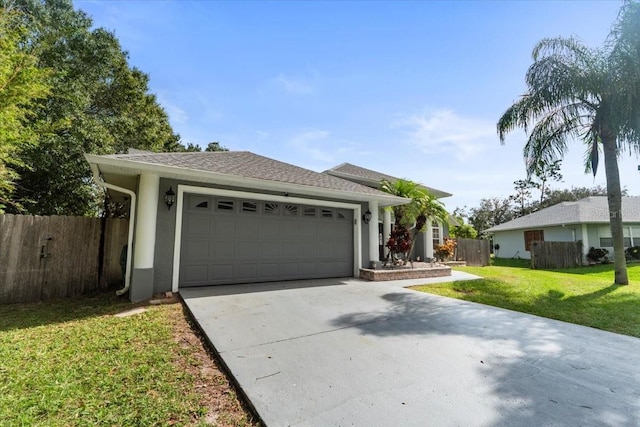 ranch-style home featuring a front lawn and a garage