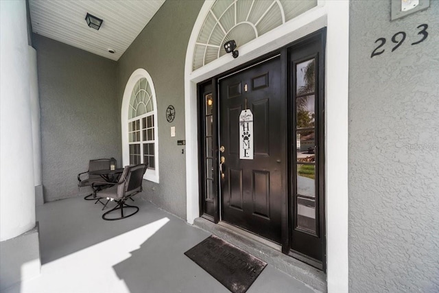 view of exterior entry featuring a porch