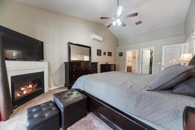 bedroom with lofted ceiling, ensuite bath, ceiling fan, a spacious closet, and light colored carpet