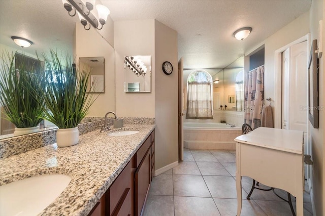 bathroom with tile patterned floors, separate shower and tub, vanity, and a textured ceiling