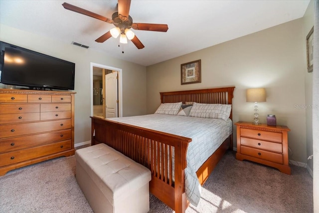 carpeted bedroom with ceiling fan and connected bathroom