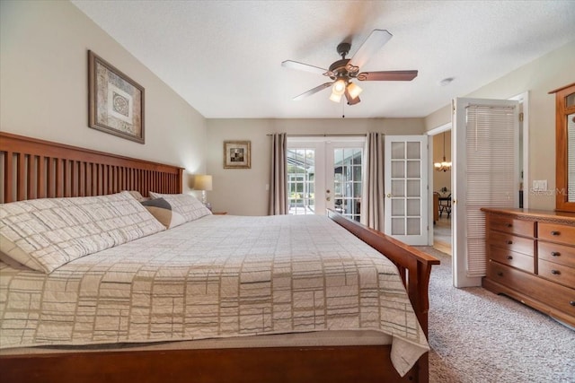 carpeted bedroom featuring french doors, a textured ceiling, access to outside, and ceiling fan