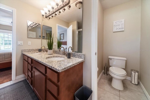 bathroom featuring vanity, tile patterned floors, ceiling fan, toilet, and a textured ceiling