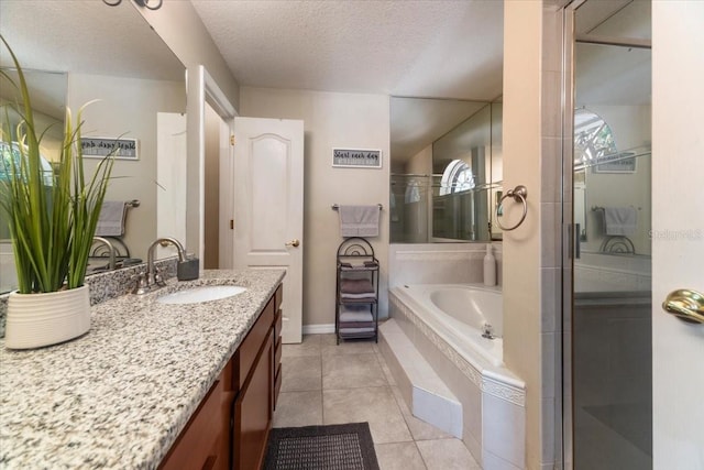 bathroom featuring vanity, a textured ceiling, tile patterned floors, and independent shower and bath