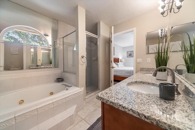 bathroom with vanity, an inviting chandelier, tile patterned floors, a textured ceiling, and independent shower and bath