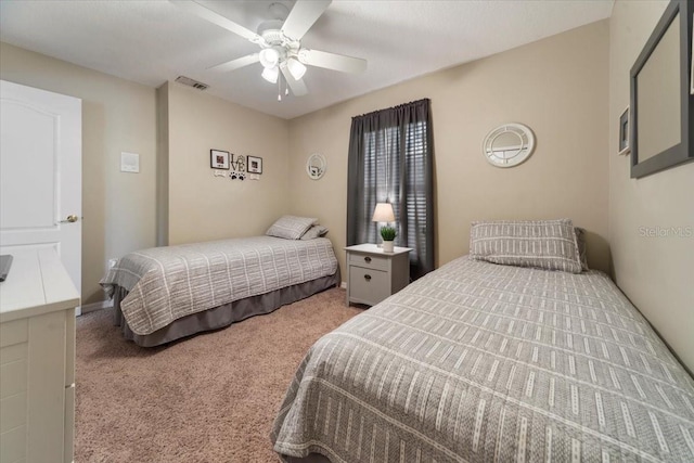 bedroom with ceiling fan and light colored carpet