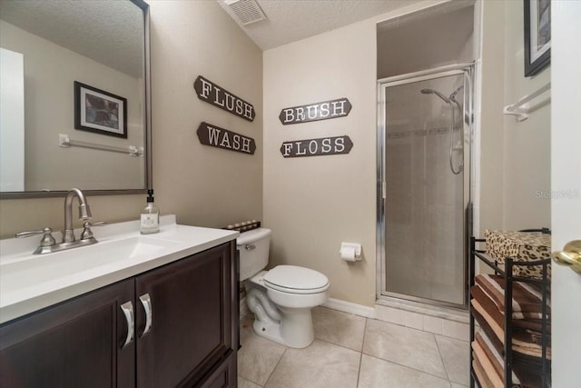 bathroom with vanity, a textured ceiling, tile patterned floors, and a shower with shower door