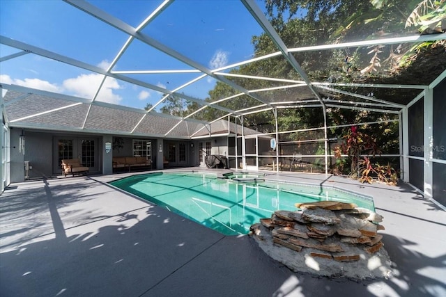 view of pool featuring a lanai, an in ground hot tub, and a patio