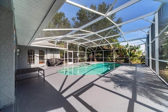 view of pool with a lanai, a patio, and french doors