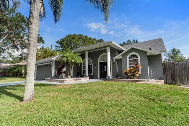 single story home featuring a front lawn and a garage