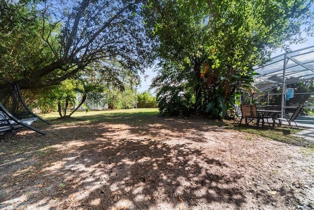 view of yard featuring a lanai