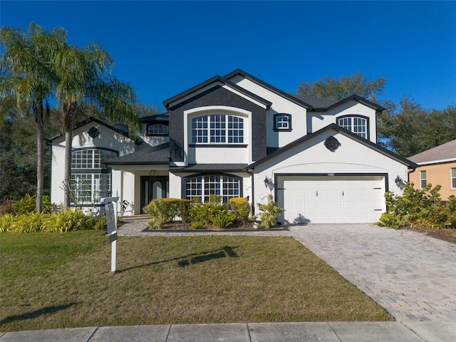 view of front of property with a garage and a front lawn