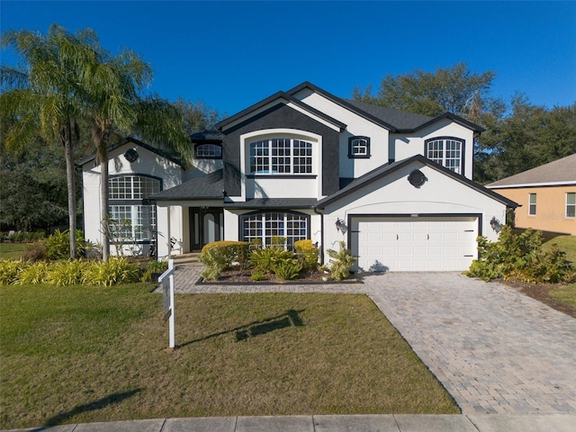 view of front of property featuring a front lawn and a garage