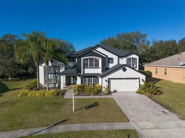 view of front of house featuring a front yard and a garage