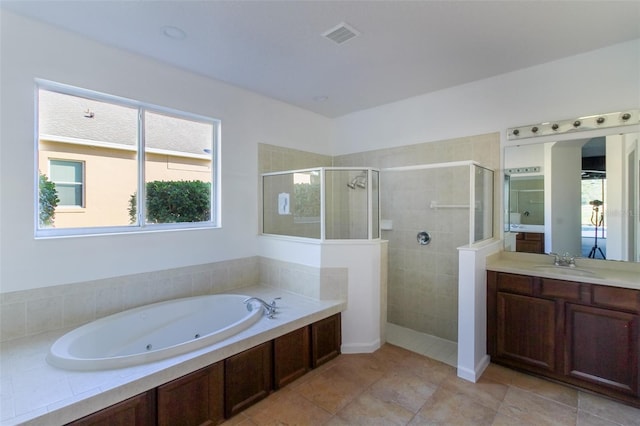 bathroom featuring vanity and separate shower and tub