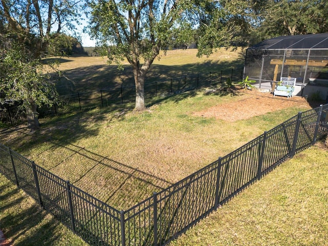 view of yard with a lanai and a rural view