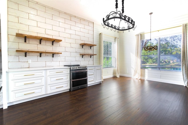 kitchen with double oven range, decorative light fixtures, dark hardwood / wood-style flooring, and white cabinets