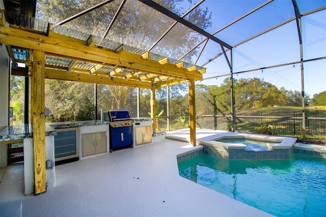 view of swimming pool with a lanai, a patio area, an in ground hot tub, and an outdoor kitchen