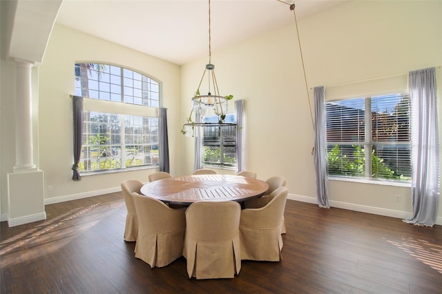 dining area with dark wood-type flooring and ornate columns