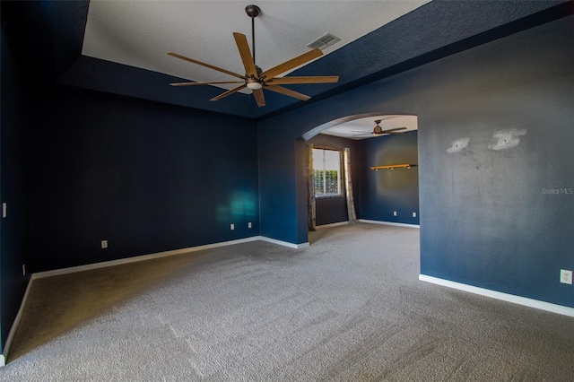 carpeted empty room with a textured ceiling and ceiling fan