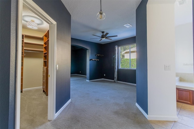 interior space with light carpet and a textured ceiling