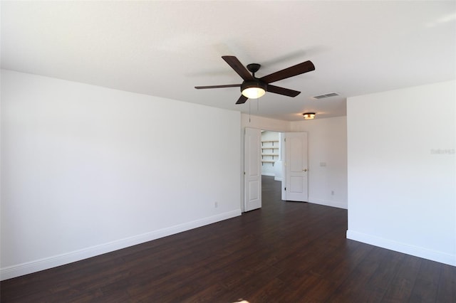 unfurnished room featuring dark wood-type flooring and ceiling fan