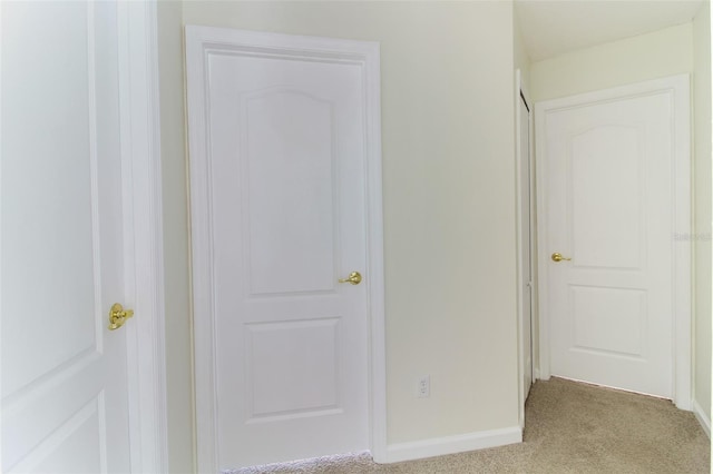 hall featuring light colored carpet