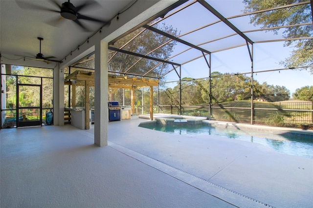 view of swimming pool featuring an in ground hot tub, ceiling fan, glass enclosure, and a patio area