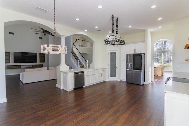 kitchen featuring white cabinets, hanging light fixtures, ceiling fan, stainless steel appliances, and dark wood-type flooring