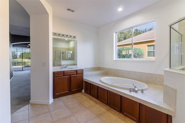 bathroom with vanity, tile patterned floors, plus walk in shower, and a healthy amount of sunlight