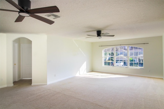 unfurnished room with light carpet and a textured ceiling