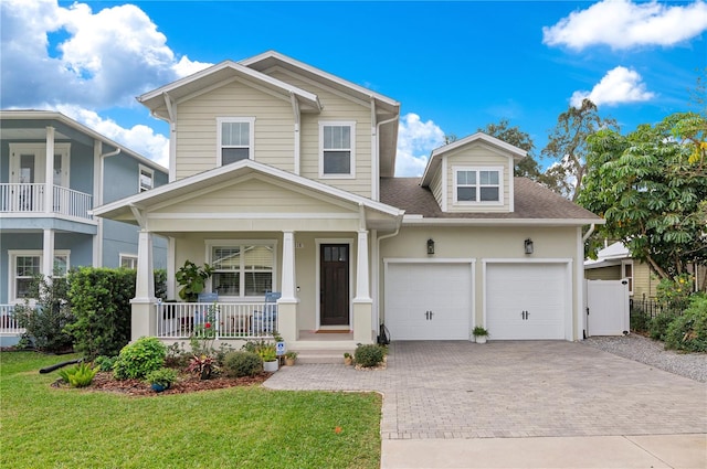 view of front facade featuring a front lawn, a porch, and a garage