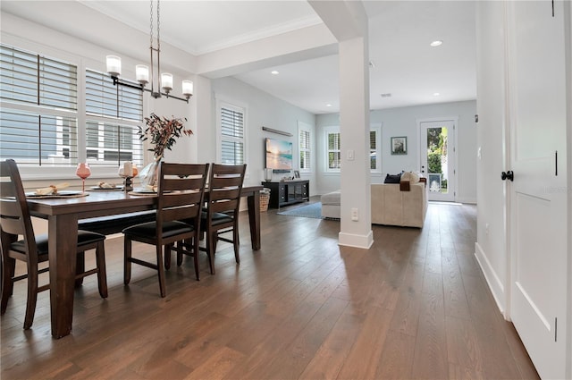 dining room featuring a chandelier, dark hardwood / wood-style floors, and ornamental molding