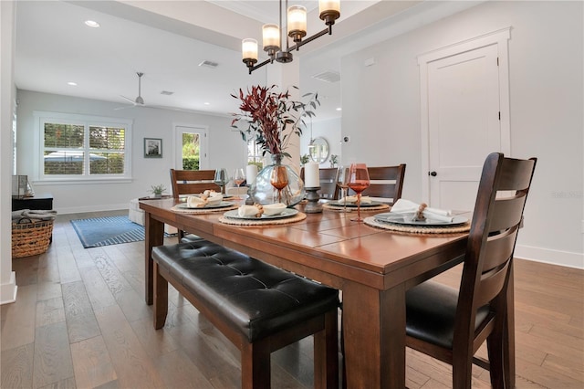 dining space with hardwood / wood-style floors, ceiling fan, and crown molding