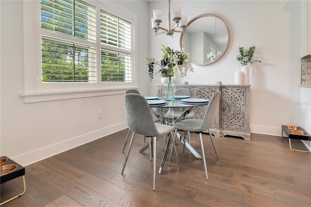 dining room with an inviting chandelier and dark wood-type flooring