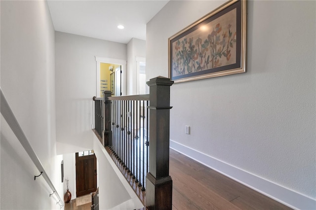 stairs with hardwood / wood-style floors