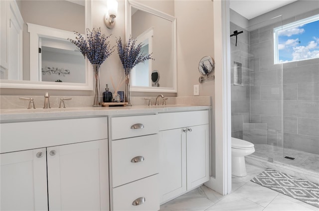 bathroom featuring tiled shower, vanity, and toilet