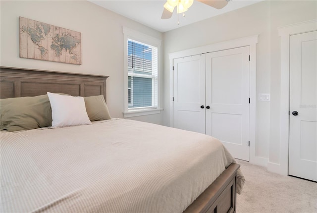 bedroom featuring ceiling fan, a closet, and light colored carpet