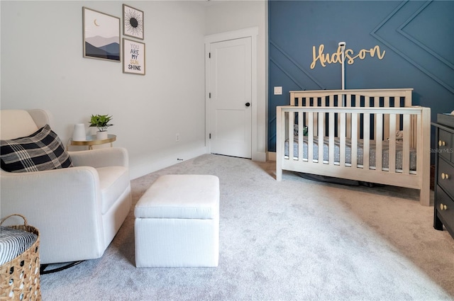 carpeted bedroom featuring a crib