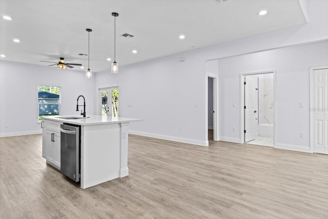 kitchen featuring ceiling fan, sink, light hardwood / wood-style flooring, an island with sink, and pendant lighting