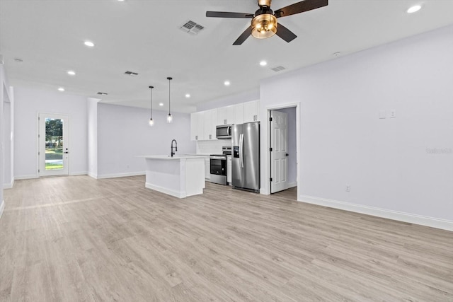 unfurnished living room with ceiling fan, light hardwood / wood-style floors, and sink