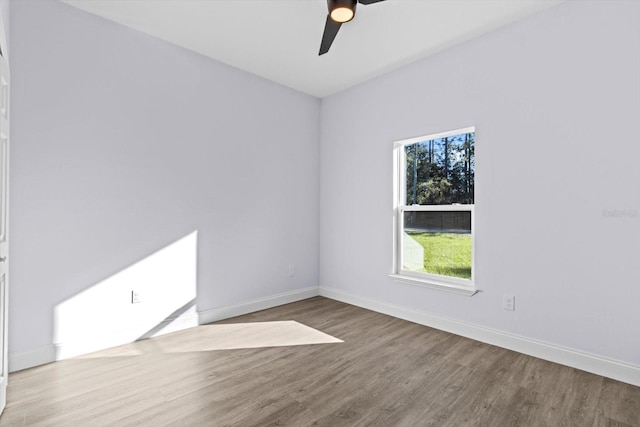 empty room featuring hardwood / wood-style flooring and ceiling fan