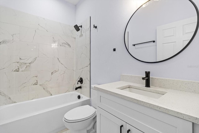 full bathroom featuring tiled shower / bath combo, toilet, and vanity