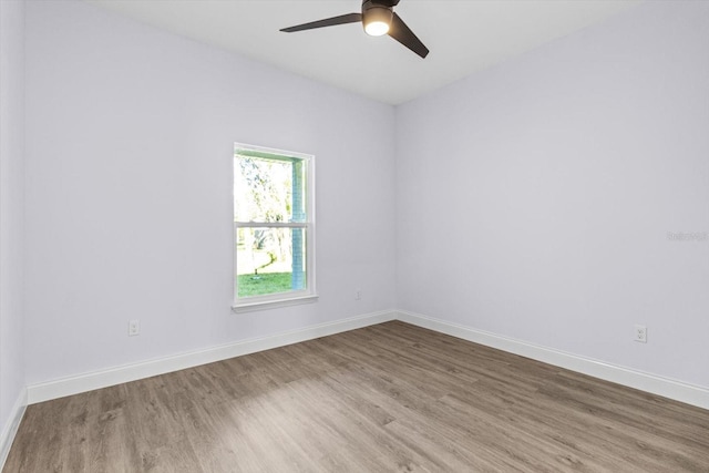 unfurnished room with ceiling fan and hardwood / wood-style floors