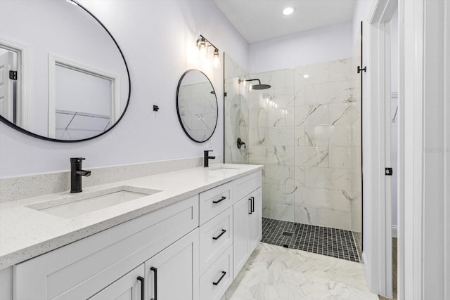 bathroom featuring tiled shower and vanity