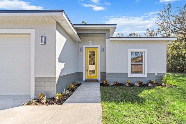 property entrance with a yard and a garage