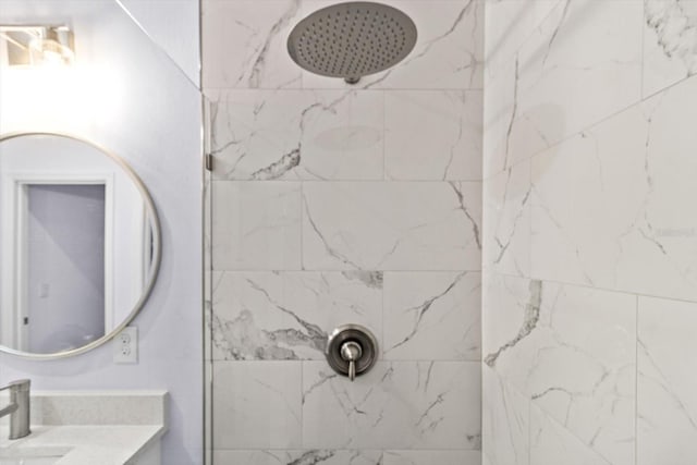 bathroom with vanity and tiled shower