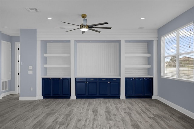 unfurnished living room featuring light wood-type flooring, built in features, and ceiling fan