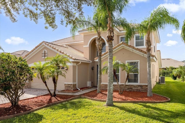 mediterranean / spanish house with a front lawn and cooling unit